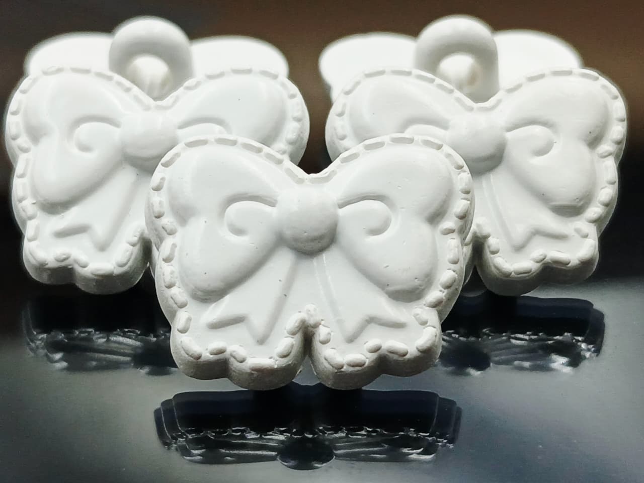 White Bow Shape Down Hole Polyester Buttons 28L
