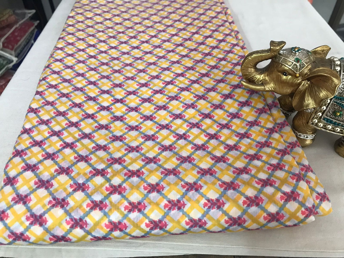 viscose-muslin-silk-pink-floral-motif-yellow-cross-pattern-print-fabric