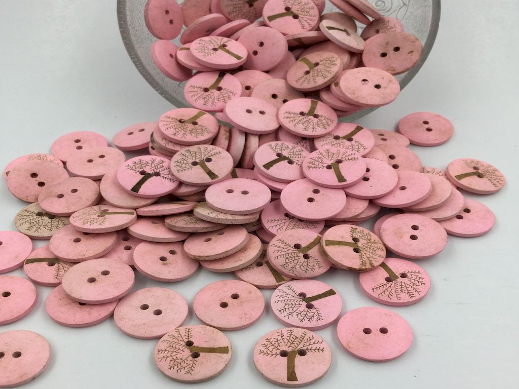 round-shaped-pink-color-wooden-button-with-tree-design-on-it