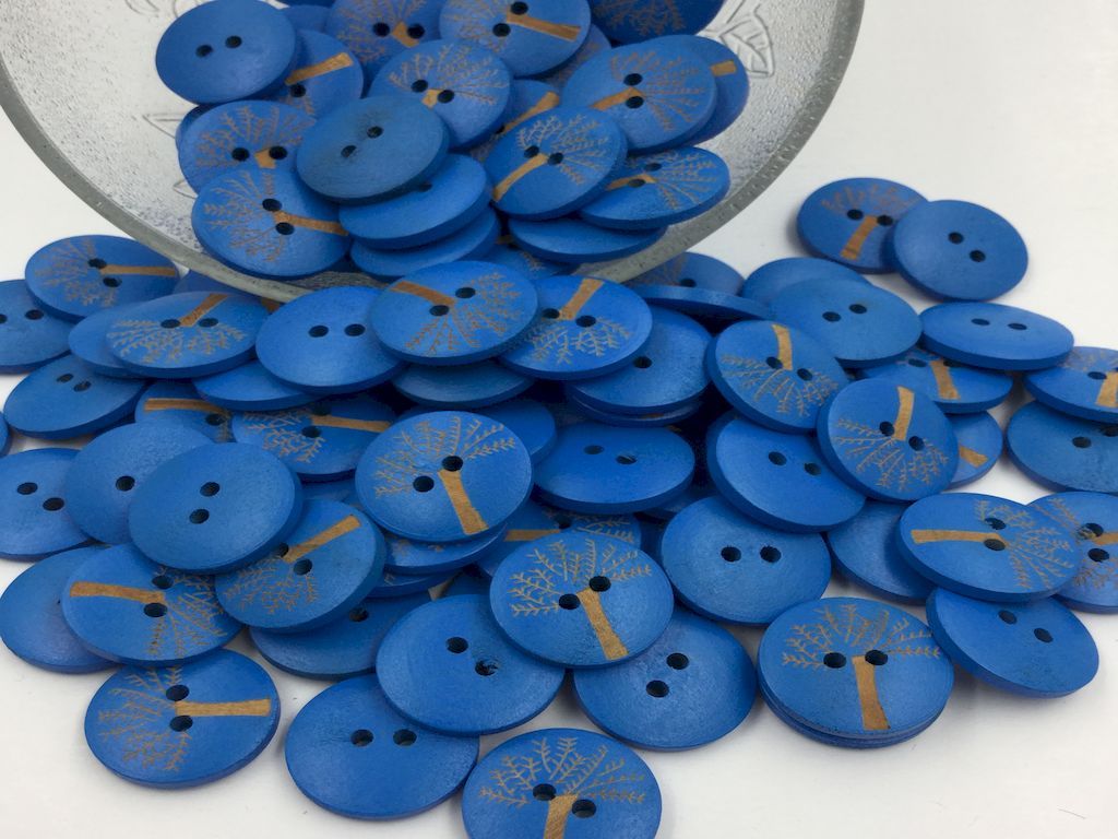 blue-color-round-shaped-wooden-button-with-tree-design-on-it