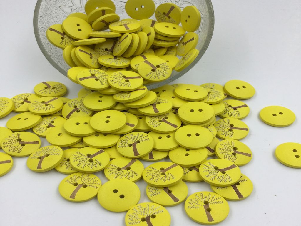 round-shaped-yellow-color-wooden-button-with-tree-deisgn-on-it