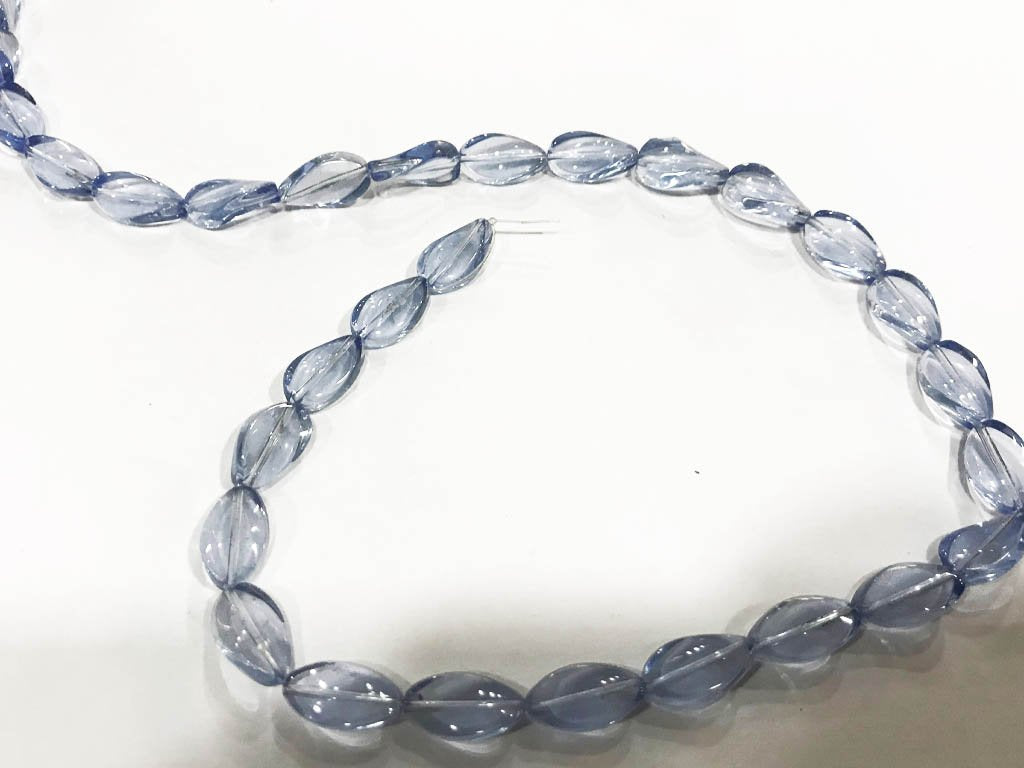 blue-transparent-twisted-oval-pressed-glass-beads-8x12-mm
