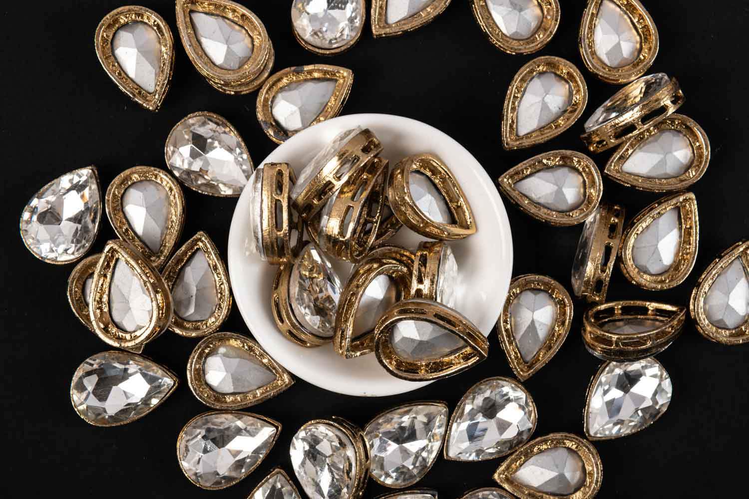 The White Moon Shape Fitting Kundan Stones are perfect for enhancing silk thread jewelry, Aari work, embroidery, and other crafts. Available in 5mm sizes, these stones come in packs of 20g, 50g, and 100g. main image 1