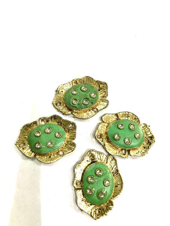 golden-oval-metal-piece-with-green-enamel