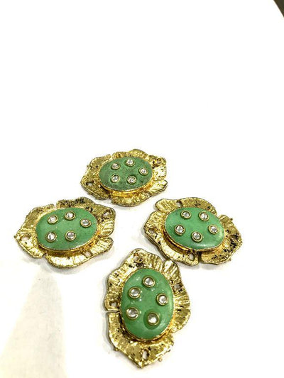 golden-oval-metal-piece-with-green-enamel