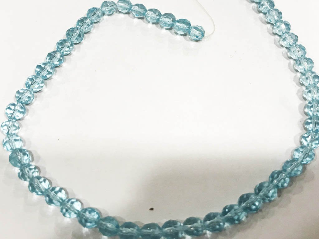 light-blue-transparent-football-pressed-glass-beads-6-mm