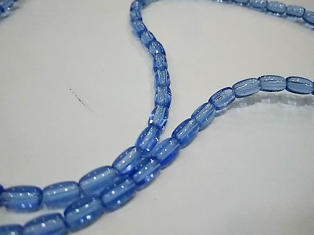 light-blue-transparent-oval-pressed-glass-beads-4x7-mm