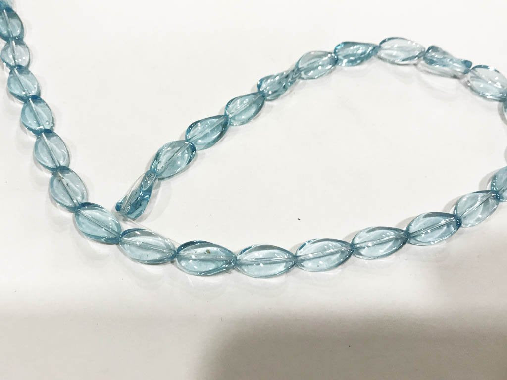 light-blue-transparent-twisted-oval-pressed-glass-beads-8x12-mm