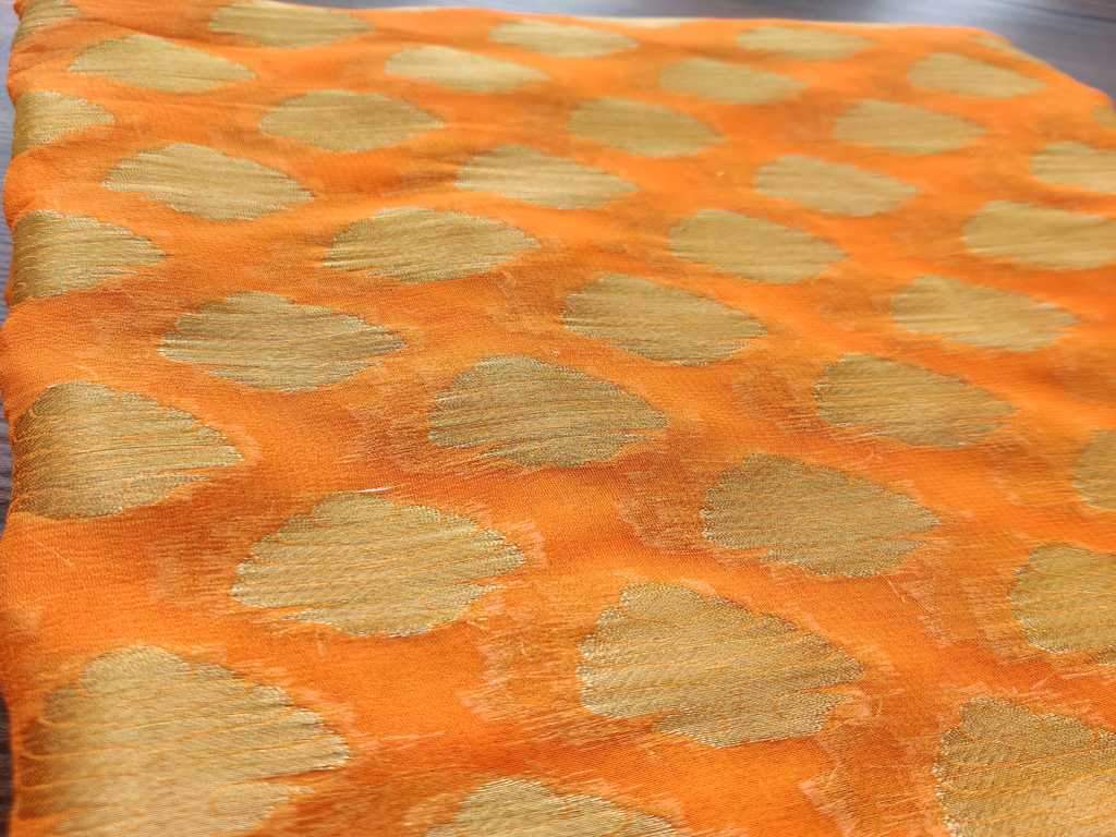 orange-fine-georgette-fabric-with-golden-buttas-all-over