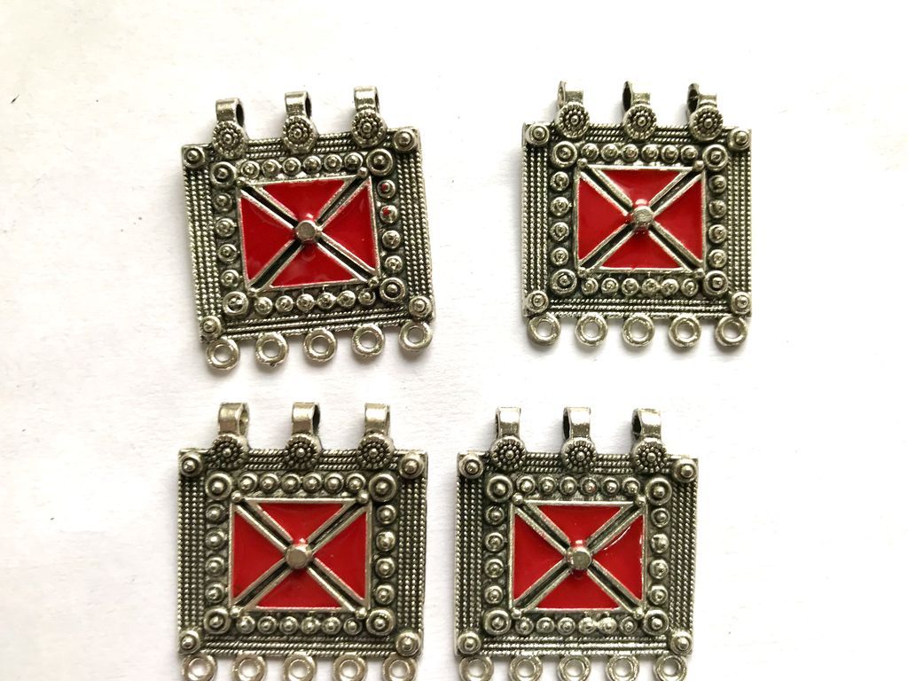 silver-metal-piece-with-red-enamel-fill