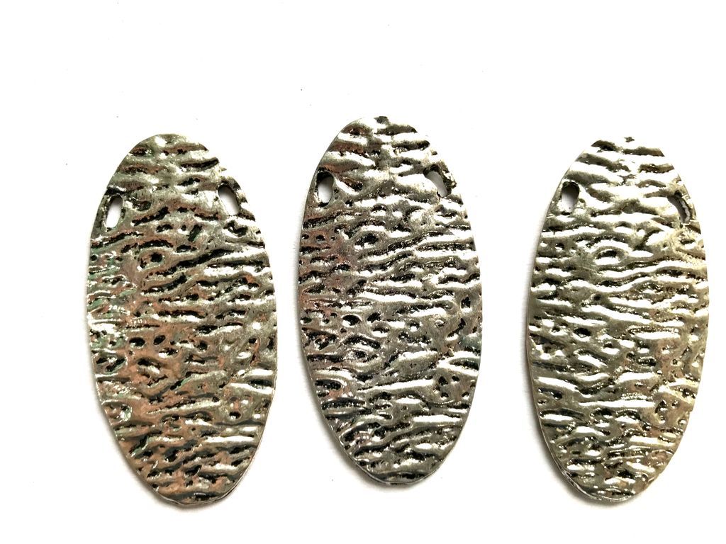 silver-oval-metal-piece-with-texture