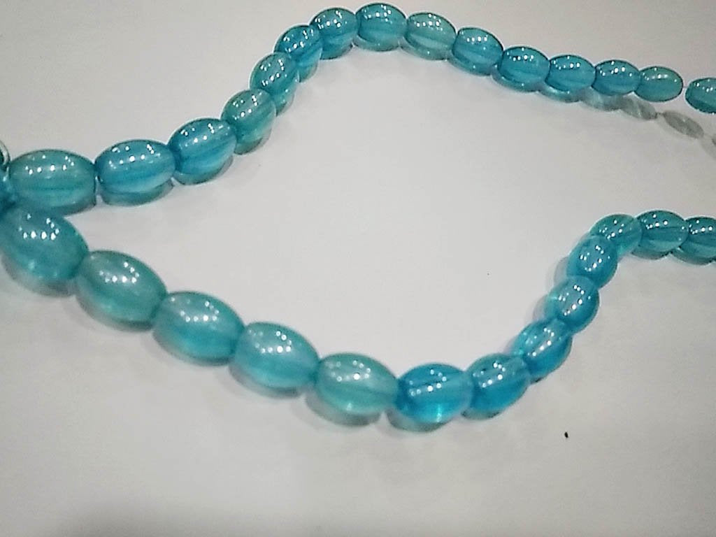 turquoise-transparent-oval-pressed-glass-beads-7x10-mm