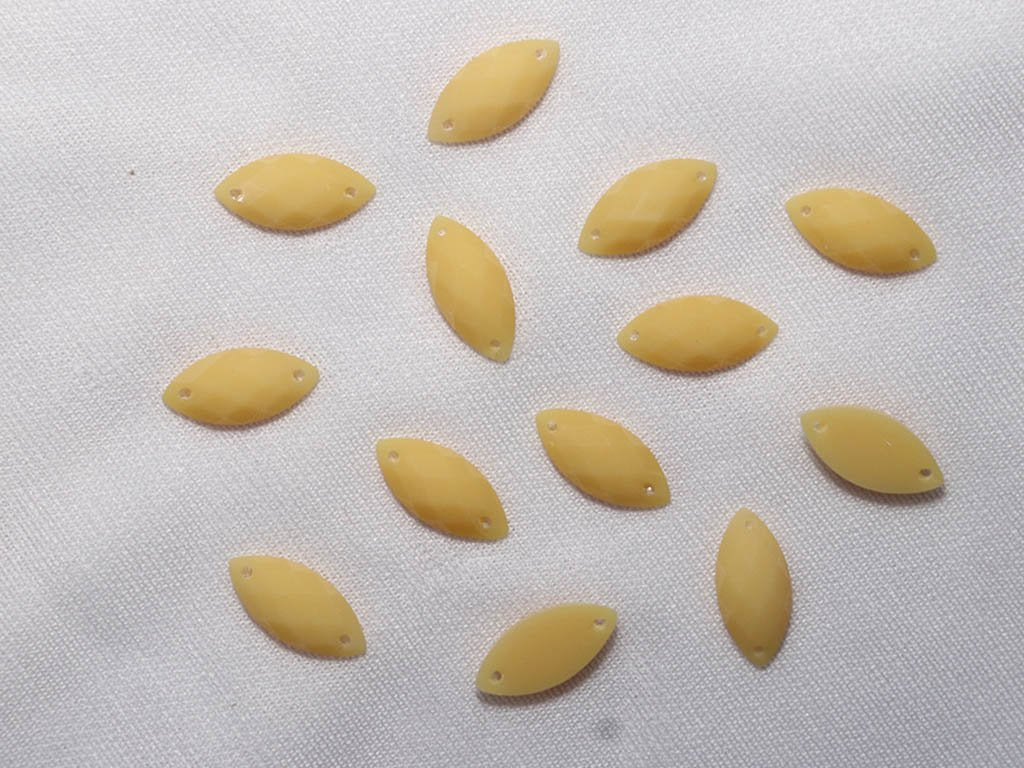 yellow-2-hole-eye-dyeable-plastic-stones-15x7-mm