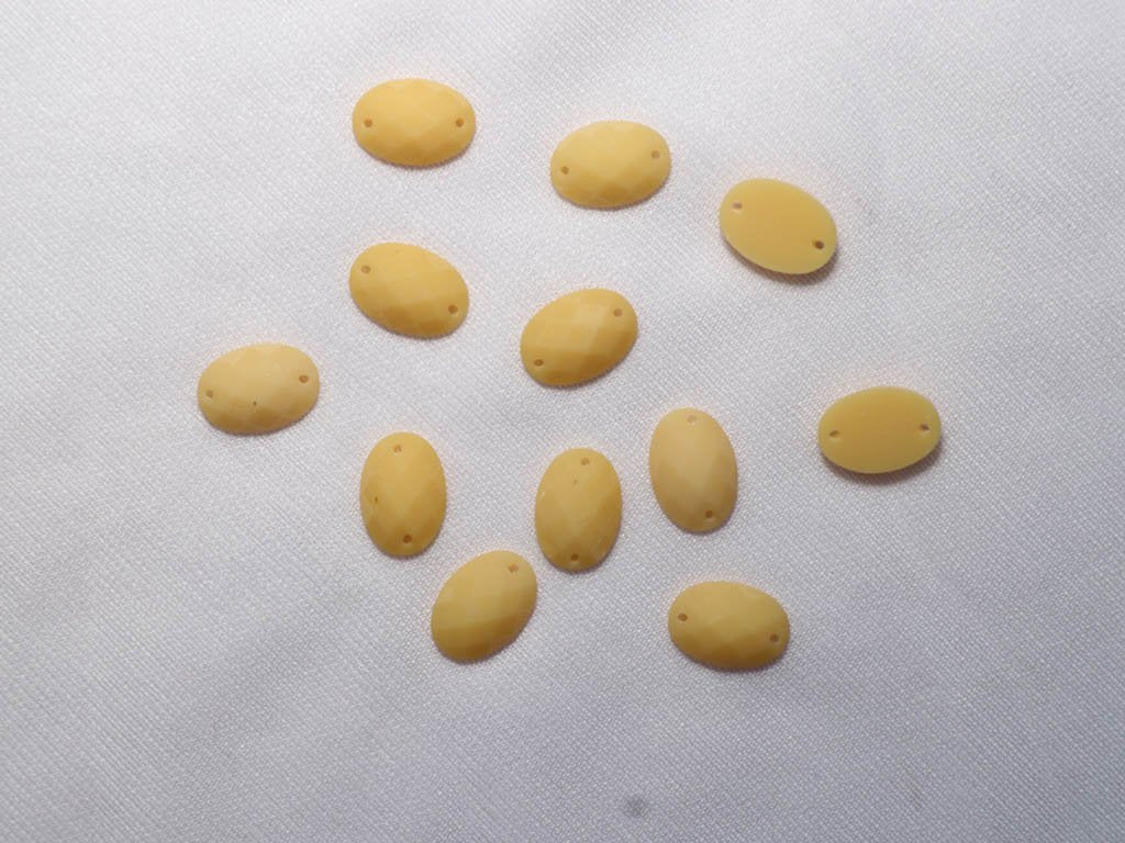 yellow-2-hole-oval-dyeable-plastic-stones-10x14-mm