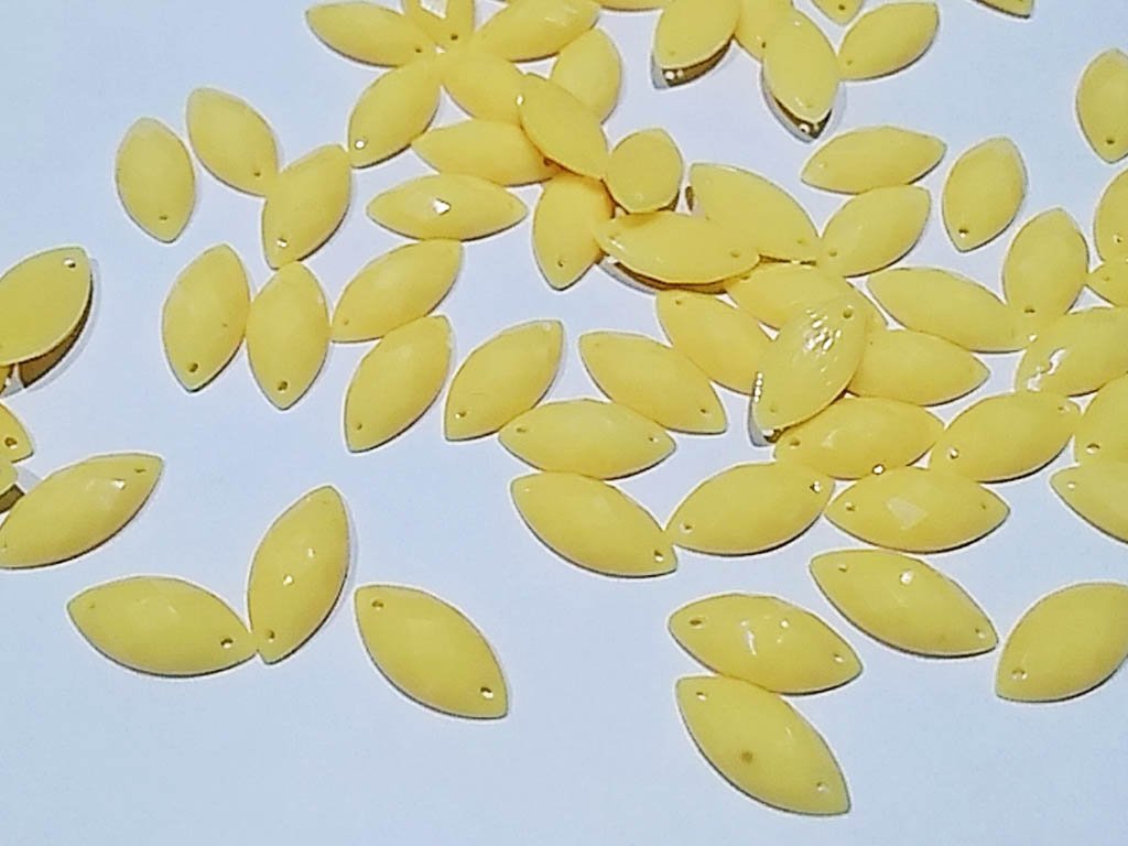 yellow-dyeable-eye-2-hole-plastic-stones-15x7-mm