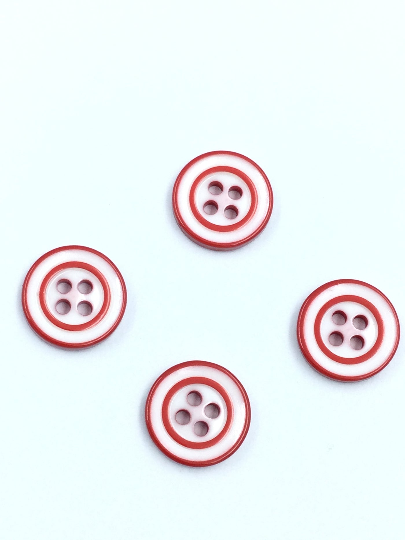 Red and white 4 hole plastic button